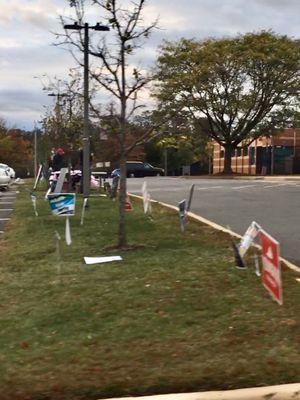 Poll signs & workers in the background