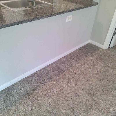 Carpet with glare from camera and indentations from furnitures