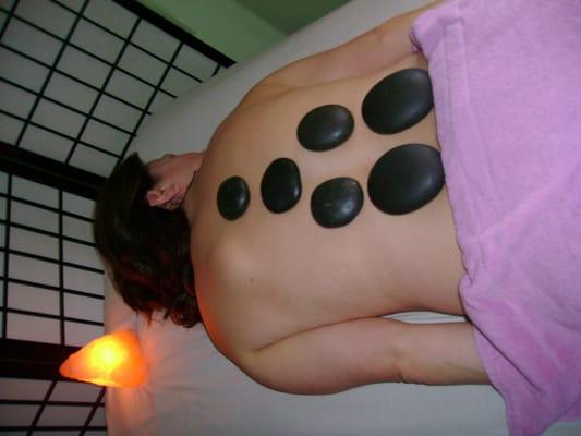 Massage with hot stones.