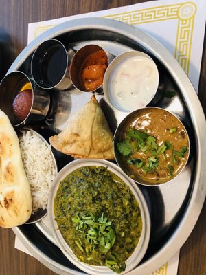 Lunch with Samosa appetizer, naan,-, Jeera rice, mango pickle, spinach and paneer curry, and lentils, Keer dessert