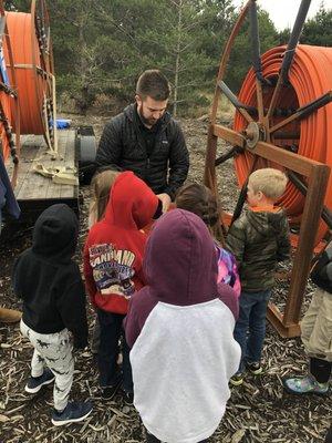 Robbie training a group of school kids about fiber optics