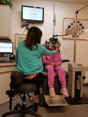 My daughter getting her eyes checked by Dr. Connie.