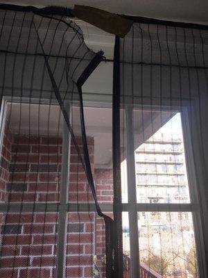 Magnetic screen door leads to patio. Top damaged by carpet installers.