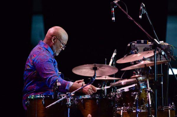 Tom Petty and the Heartbreakers drummer Steve Ferrone wearing Migration men's shirt.