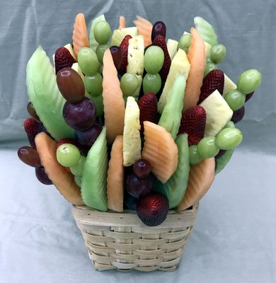 Edible arrangements fruit bouquet or fruit basket.