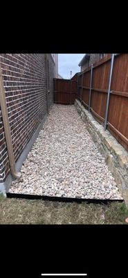 Rock landscape install on a messy/muddy side yard