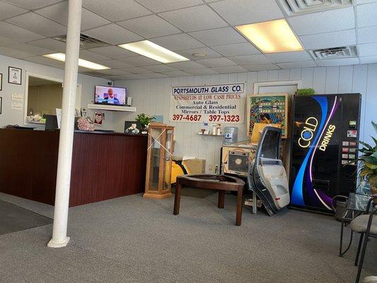 Other check in desk, TV, vending machine and chairs