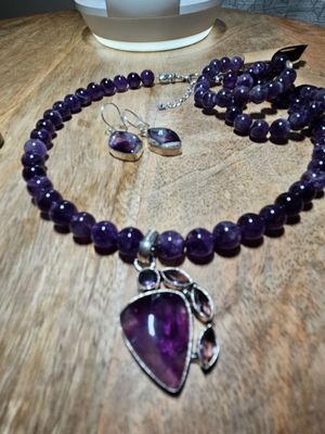 Beautiful semiprecious stones of natural amethyst 10mm beads, custom pendant with a pair of beaded bracelets and custom earrings.