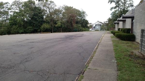 Large level well lit parking lot accommodates vehicles of all sizes