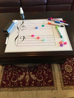 A whiteboard is used as another tool to practice notation.