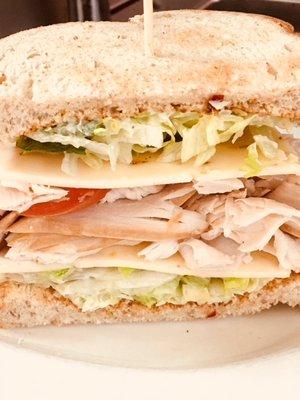 Turkey Avocado Sandwich is piled high with meat, the avocado aioli is delicious