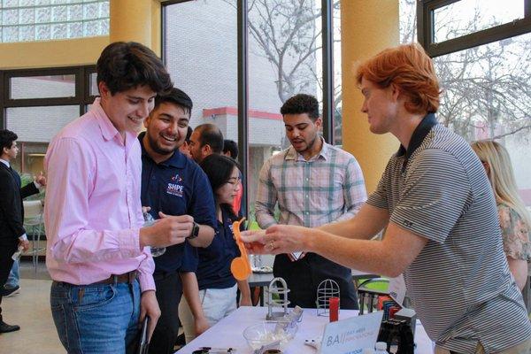 Eric from our team talking to USF engineering students at the SHPE career fair.