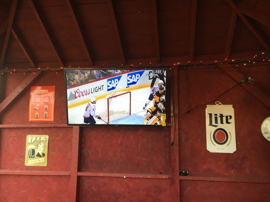 Outdoor seating with a TV.