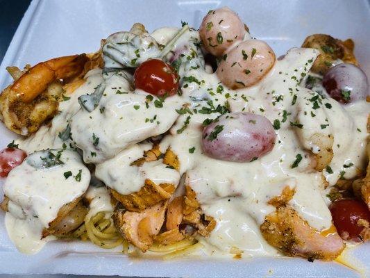 Salmon lump crab colossal shrimp with Alfredo pasta