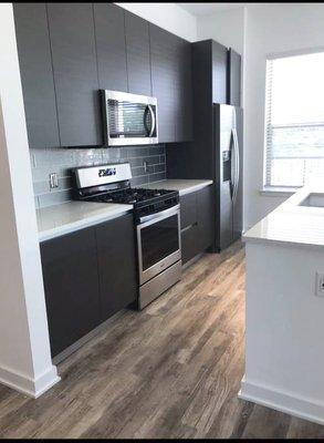 Installation of counter tops, cabinets, wood floors, and service plumbing.