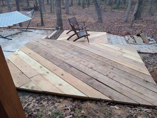 A simple small 2 level deck, seating room for 8 to 10. Angled towards the fireplace in one corner, angled deck boards for a more modern look