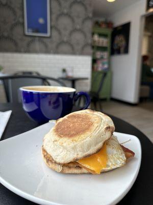 One egg breakfast sandwich with cheddar and bacon.