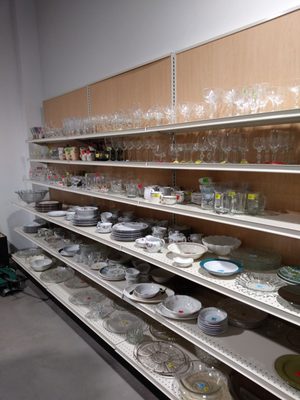 Rows of inexpensive dishware all sparkling clean.