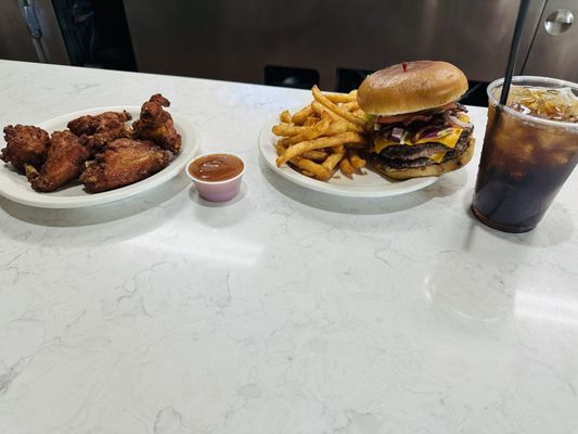 Plain wings with mango habanero sauce on the side, doble bacon cheeseburger, and a coke.