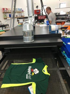 A shot of the Bowen Design & Print Screen Printing Conveyor Dryer working up 350 sports shirts / jerseys for a client in Seattle, WA.