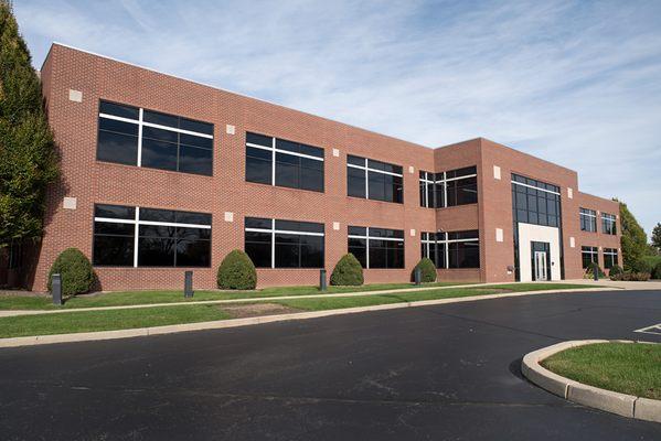 Business building with fresh asphalt in their parking lot.