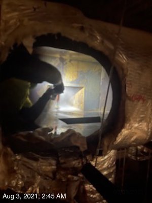 Guys cleaning access panels of kitchen hood in ceilings