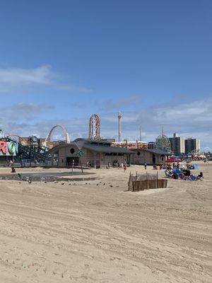 The beach, with the rides in the background