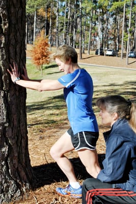 Coach Janet Hamilton - helping a runner with some stretching techniques.