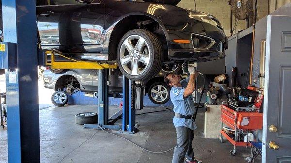 ASE certified technician working on a car A/C Compressor replaced