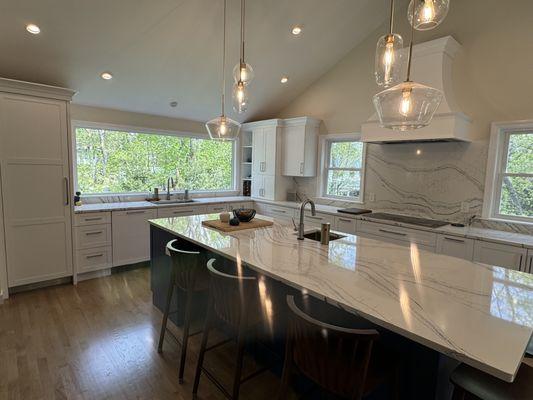 large window overlooking back yard lets in lots of natural light in this beautiful transitional kitchen.