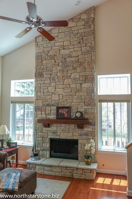 Two-story stone veneer fireplace in Grayslake