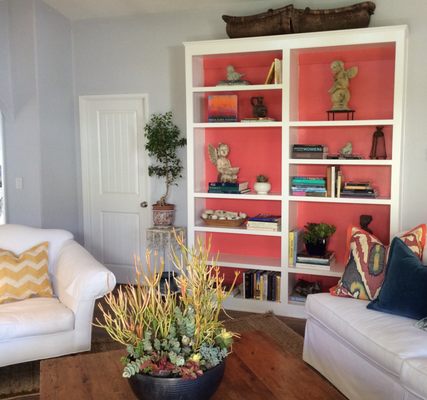 Color was added to the back of the bookcase to coordinate with other small touches in the living room to make the whole room POP!