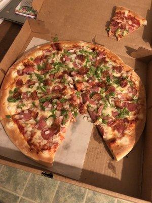 Large pizza with sausage, green pepper, onion, & bacon