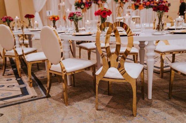 Gold stainless steel chairs available to view in our showroom. White Acrylic "S" table