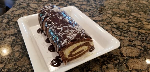 Coconut chocolate and peach roll with semisweet ganache.