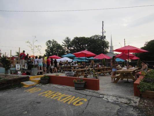 16 picnic tables, most with umbrellas.