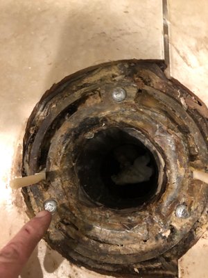 This is the original toilet flange with new anchors , NO earth pushing up the pipes, below the tile height, Big lie $100 taken no repair.