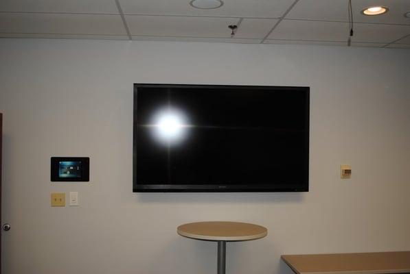 70" Sharp and a in-wall motorized iPad docking station.