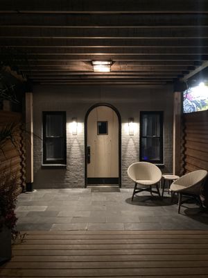 Exterior light installation on wall and pergola