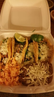 Steak and carnitas tacos with rice & beans