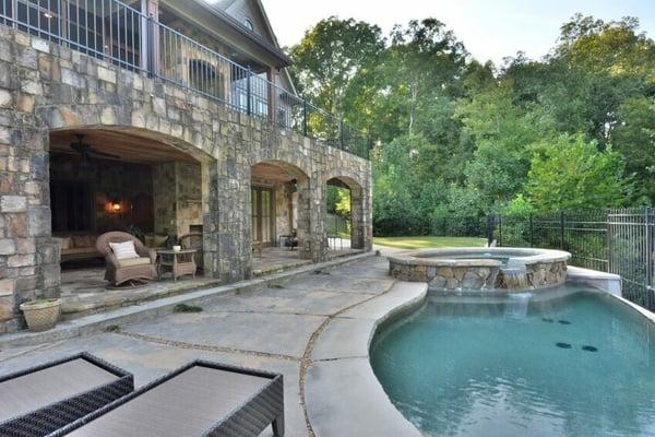 Lake Lanier home. Backyard includes a gunite infinity pool and large hot tub all surrounded by a beautiful wrought iron fence.