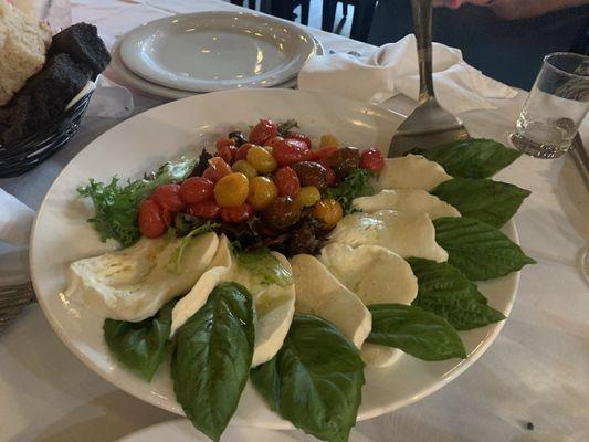 Caprese salad with homemade fresh mozzarella and fire roasted tomatoes.