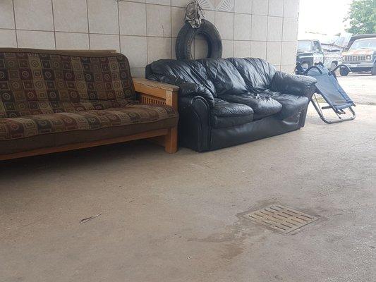 Outdoor waiting area underneath an unused self-serve car wash.