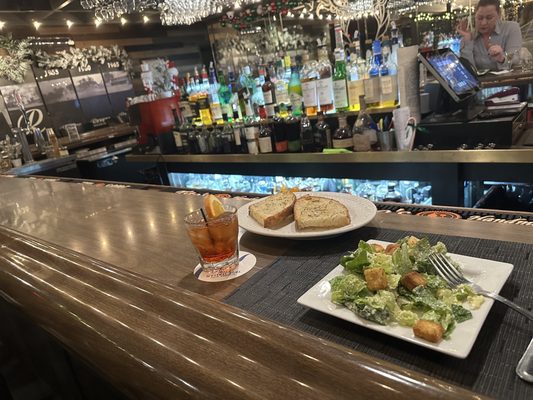 At the bar with a ceasar salad, bread and a Negroni to start.