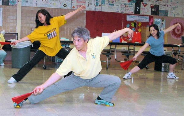 We provide Tai Chi Chuan and Tai Chi Fan (pictured) classes free of charge for parents of enrolled students.