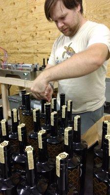 Our distiller, putting the final touch on the first round of bottles, June 2017.