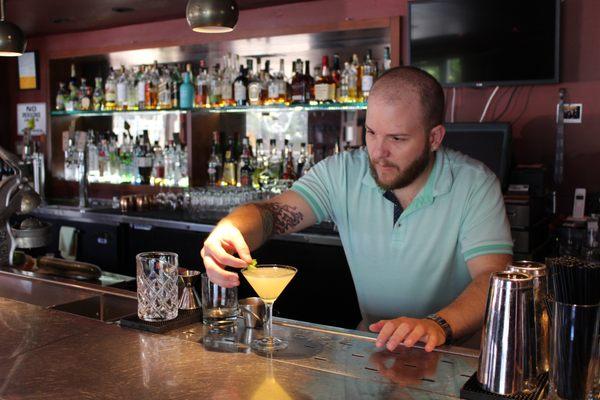 Sam putting the final touches on the FLOWER CHILD cocktail by The Groovy Bartender