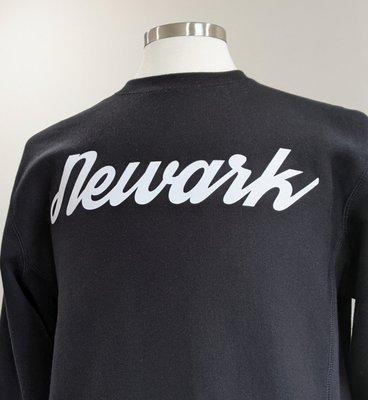 The Newark Tees Printing Co. sweatshirt screen printed in the signature cursive lettering.