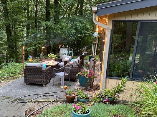 Sunroom siding and wine barrel patio table on casters for ease of movement and to prevent rotting.