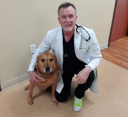 Dr.  Hart and his therapy dog Ranger.